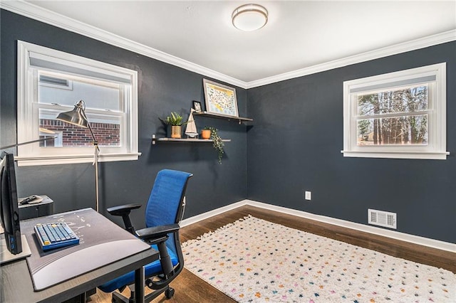 home office featuring baseboards, crown molding, visible vents, and wood finished floors