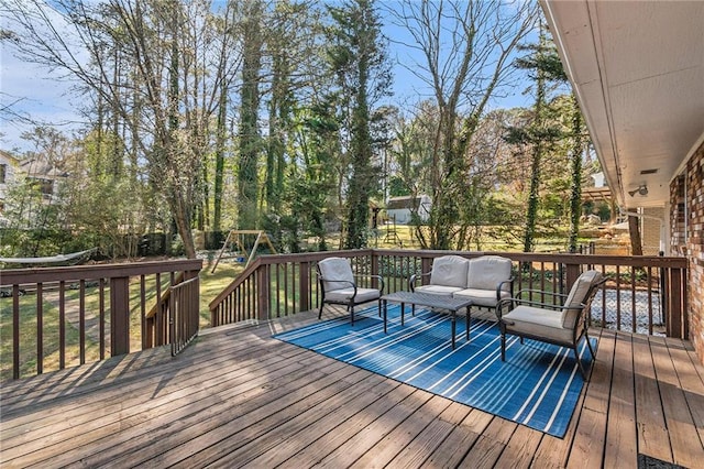 wooden terrace featuring a playground and an outdoor hangout area