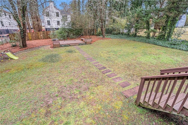 view of yard featuring fence and a wooden deck