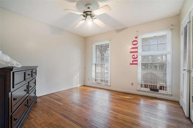 interior space with wood-type flooring and ceiling fan