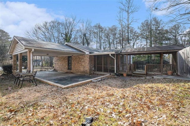 exterior space featuring a patio area and a sunroom