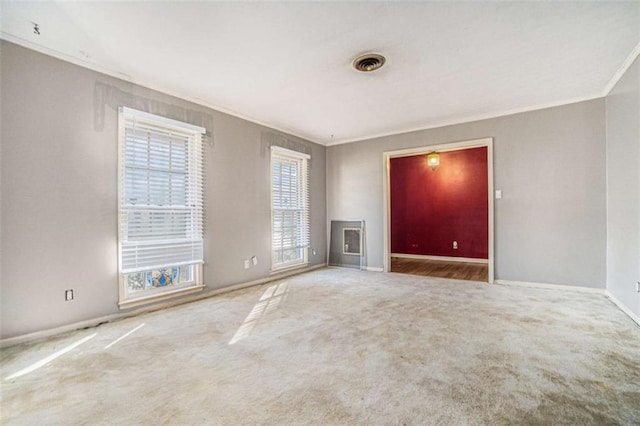 unfurnished room featuring carpet and crown molding