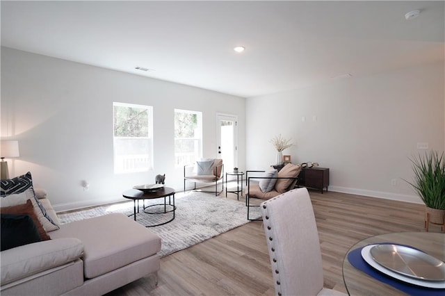 living room featuring visible vents, recessed lighting, baseboards, and wood finished floors