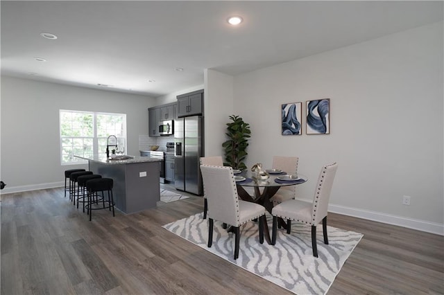 dining area with recessed lighting, baseboards, and dark wood-style floors