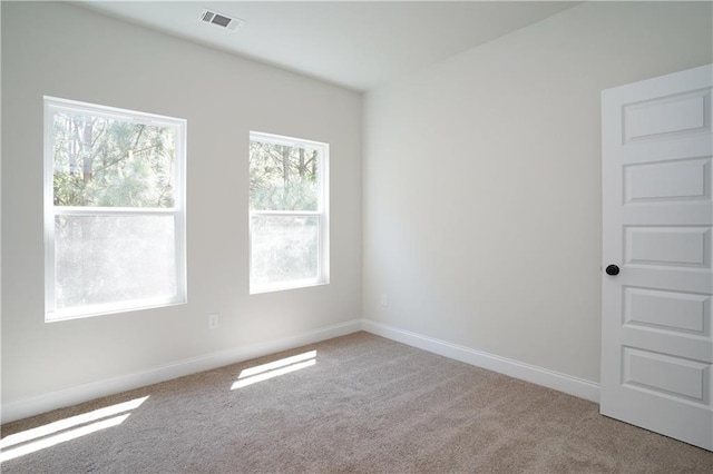 carpeted empty room with baseboards and visible vents