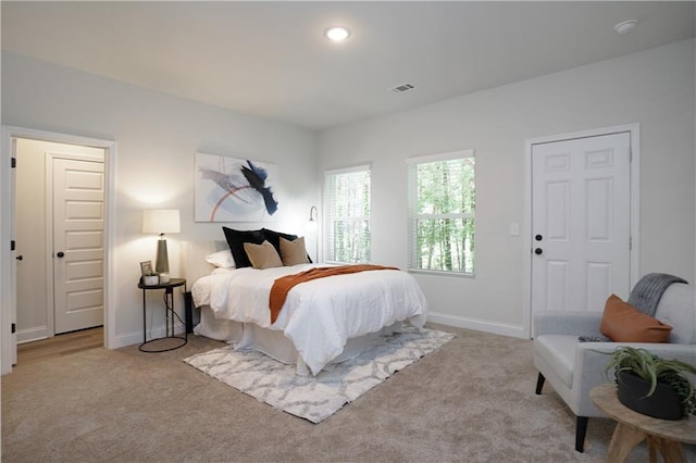 bedroom with carpet floors, baseboards, and visible vents