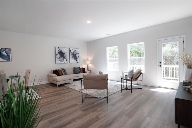living room with baseboards, recessed lighting, and wood finished floors