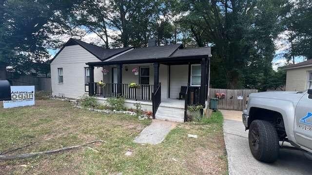 bungalow with a porch and a front yard