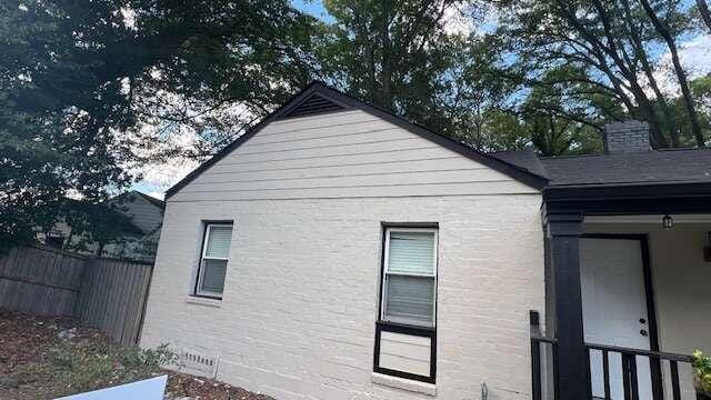 view of side of property with covered porch