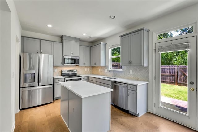 5312 Brooklands Dr, Lithonia, GA 30058 - kitchen featuring stainless steel appliances, gray cabinets, light wood-type flooring, backsplash, and recessed lighting