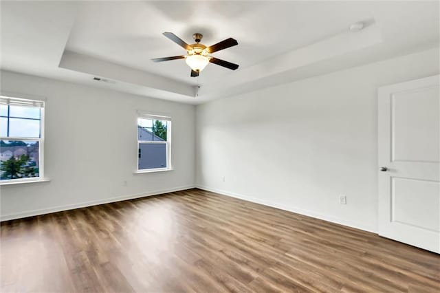 5312 Brooklands Dr, Lithonia, GA 30058 - unfurnished room featuring a raised ceiling, wood finished floors, ceiling fan, and a smoke detector