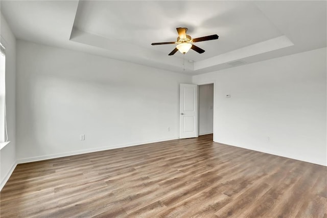 5312 Brooklands Dr, Lithonia, GA 30058 - spare room with a tray ceiling, wood finished floors, and a ceiling fan