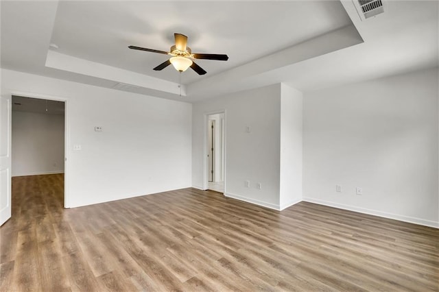 5312 Brooklands Dr, Lithonia, GA 30058 - unfurnished room with a raised ceiling, a ceiling fan, and wood finished floors