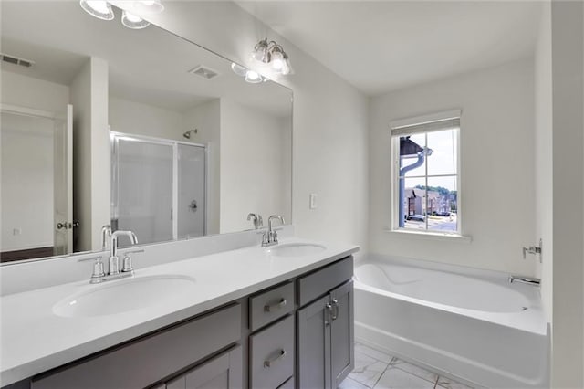5312 Brooklands Dr, Lithonia, GA 30058 - full bath with double vanity, a garden tub, a shower stall, and marble finish floors