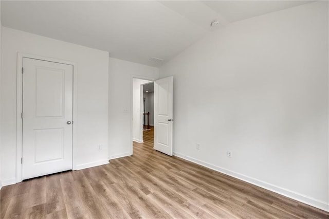 5312 Brooklands Dr, Lithonia, GA 30058 - unfurnished bedroom featuring wood finished floors and lofted ceiling