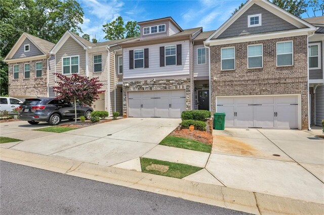 5312 Brooklands Dr, Lithonia, GA 30058 - multi unit property featuring an attached garage, concrete driveway, stone siding, and brick siding
