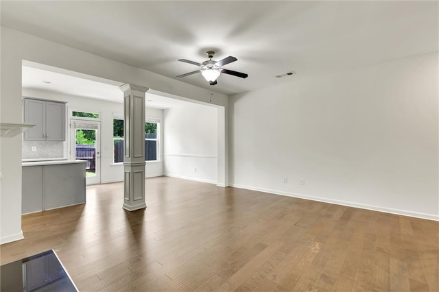 5312 Brooklands Dr, Lithonia, GA 30058 - unfurnished living room featuring decorative columns, ceiling fan, and wood finished floors