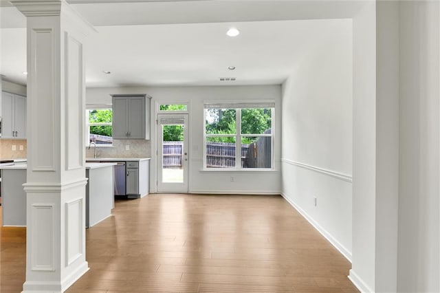 5312 Brooklands Dr, Lithonia, GA 30058 - unfurnished living room with decorative columns, plenty of natural light, wood finished floors, and recessed lighting