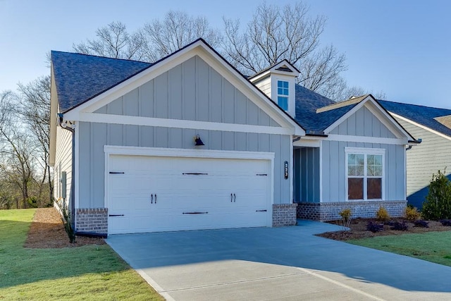 view of front of house featuring driveway, roof with shingles, an attached garage, board and batten siding, and brick siding