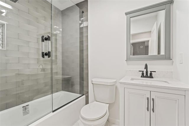 full bathroom featuring toilet, combined bath / shower with glass door, and vanity