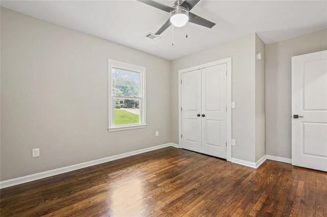 unfurnished bedroom with a closet, ceiling fan, and dark hardwood / wood-style floors