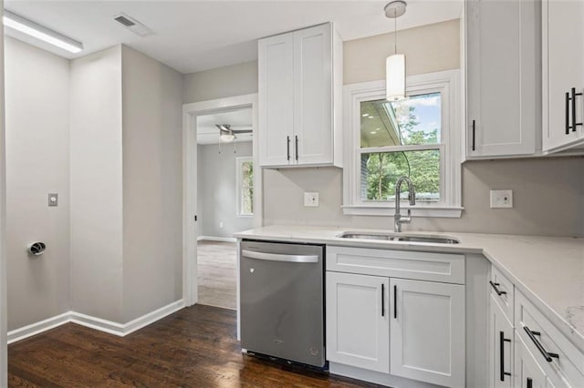 kitchen with dark wood-type flooring, hanging light fixtures, sink, stainless steel dishwasher, and white cabinetry