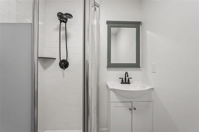 bathroom with vanity and a shower with shower door