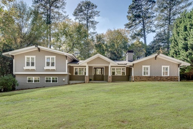 rear view of house featuring a lawn