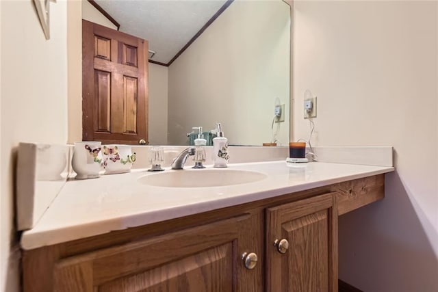 bathroom with vanity and crown molding