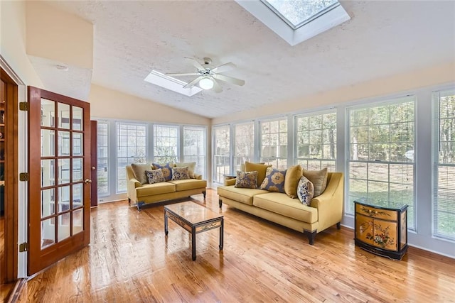 sunroom featuring vaulted ceiling with skylight and ceiling fan