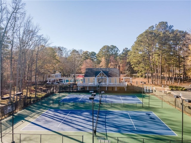 view of sport court featuring fence