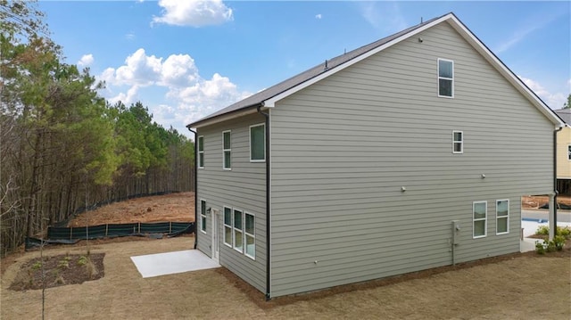 view of side of home with fence