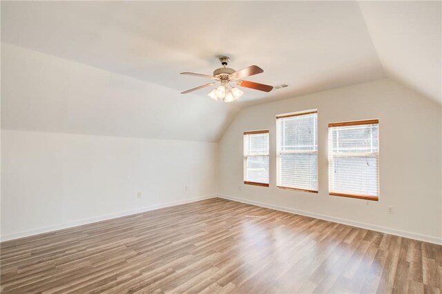 bonus room with light wood-type flooring, ceiling fan, and lofted ceiling