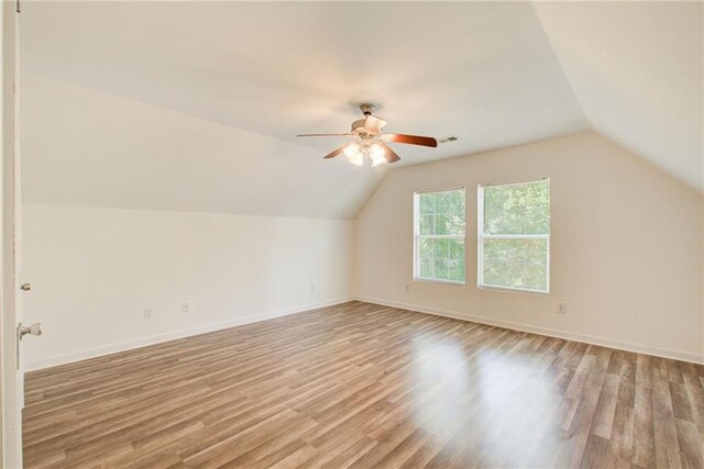 bonus room featuring ceiling fan, lofted ceiling, and light wood-type flooring