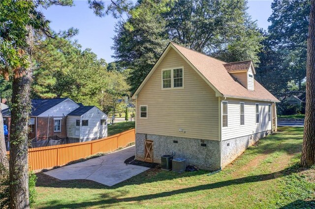 back of house with a yard and a patio