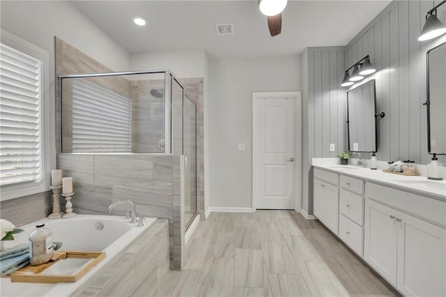 full bathroom with a shower stall, double vanity, visible vents, and a garden tub