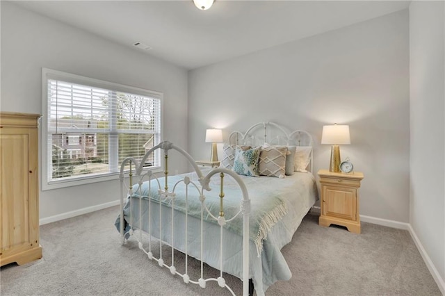 bedroom with carpet floors, baseboards, and visible vents