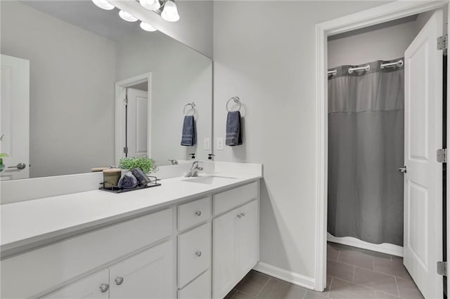 full bath featuring vanity, baseboards, tile patterned flooring, and a shower with curtain