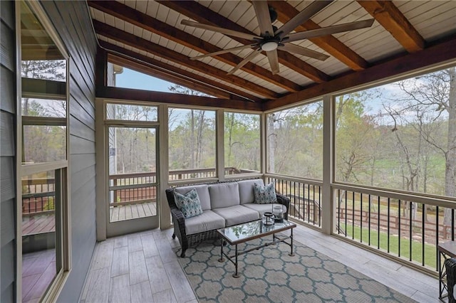 sunroom / solarium with outdoor lounge area, ceiling fan, and beamed ceiling