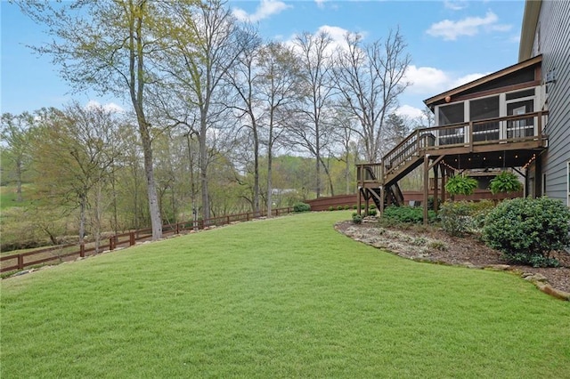 view of yard featuring stairway, a deck, and fence