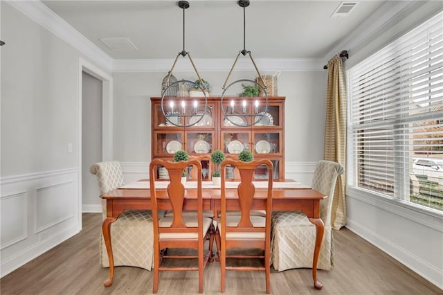 dining room with ornamental molding, visible vents, and a healthy amount of sunlight