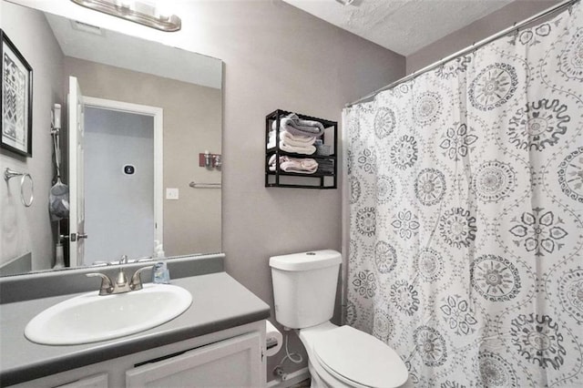 bathroom featuring toilet, curtained shower, and vanity