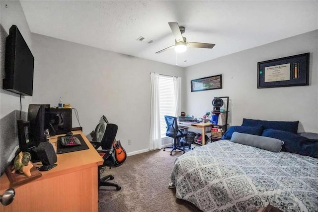 carpeted bedroom featuring a ceiling fan, visible vents, and baseboards