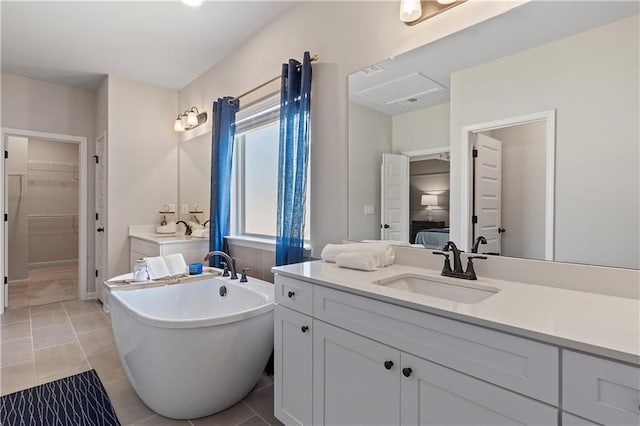 bathroom featuring tile patterned flooring, vanity, and a bathtub