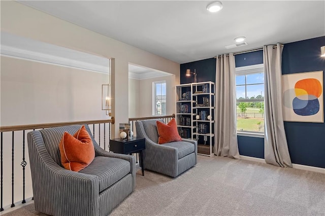 living area with crown molding and carpet floors