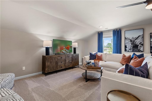 carpeted living room featuring ceiling fan and vaulted ceiling