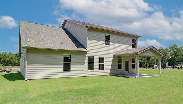 rear view of house featuring a lawn and a patio area