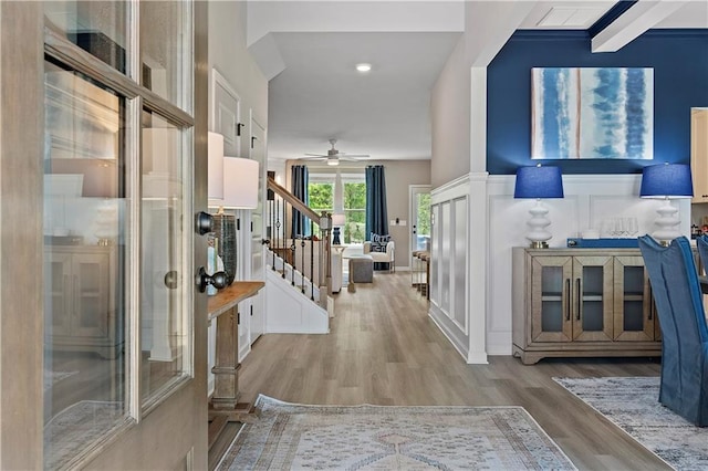 foyer with light wood-type flooring and ceiling fan