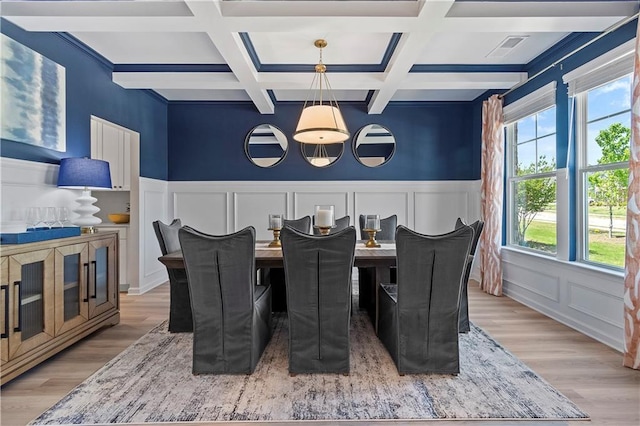 dining room with beamed ceiling, wood-type flooring, and coffered ceiling