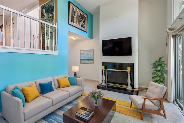 carpeted living room with a towering ceiling